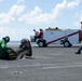 U.S. Sailor takes photos on the flight deck