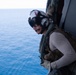 U.S. Navy Aircrewman (Helicopter) prepares for a vertical replenishment-at-sea exercise with an MH-60S Sea Hawk on the flight deck of the aircraft carrier USS John C. Stennis