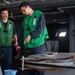 U.S. Sailors rinse a cable for a torpedo countermeasure system