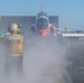 U.S. Sailor directs a T-45C Goshawk jet attached to Chief of Naval Air Training Command for launch off the flight deck of the aircraft carrier USS John C. Stennis