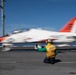 U.S. Sailor directs a T-45C Goshawk jet attached to Chief of Naval Air Training Command for launch off the flight deck of the aircraft carrier USS John C. Stennis