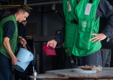 U.S. Sailors rinse a cable for a torpedo countermeasure system