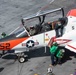 U.S. Sailors perform a turnaround inspection on a T-45C Goshawk training aircraft.
