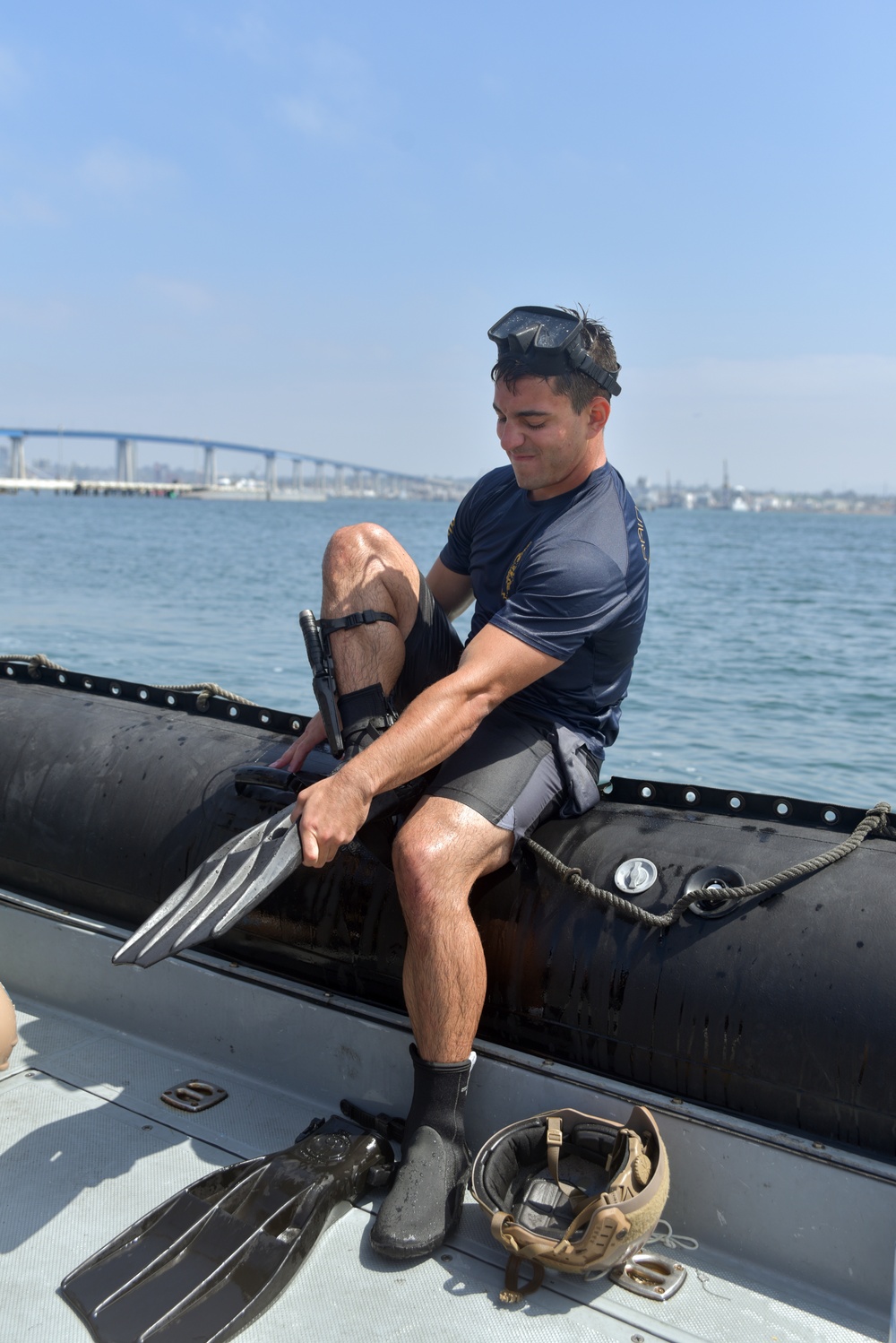 Navy Diver Puts On Swim Fins