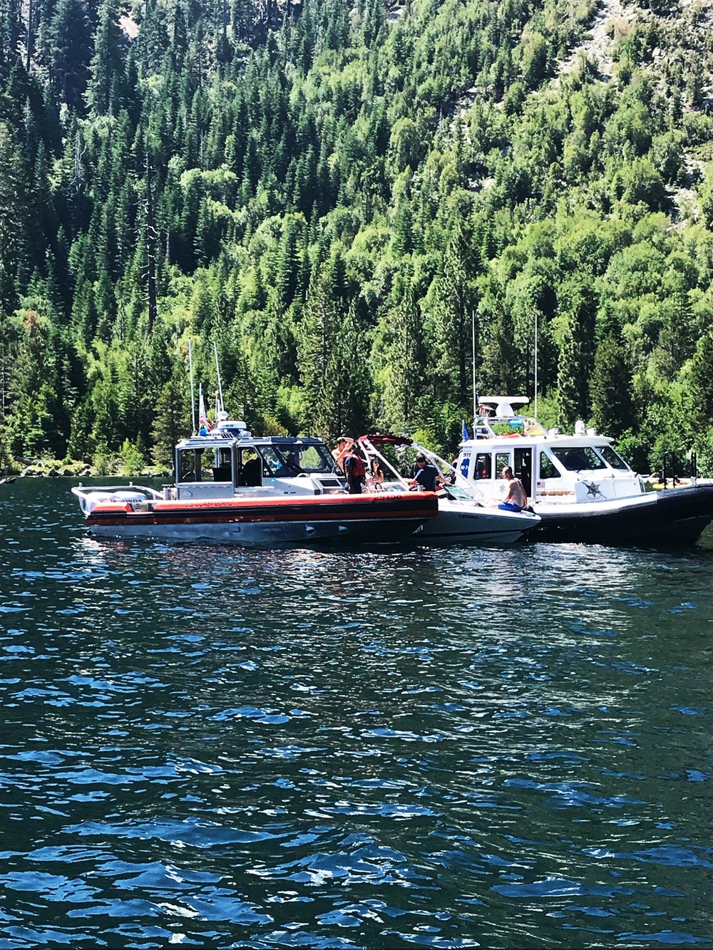 Coast Guard Station Lake Tahoe and El Dorado Sherriff's Department crews interact with a suspected illegal charter vessel