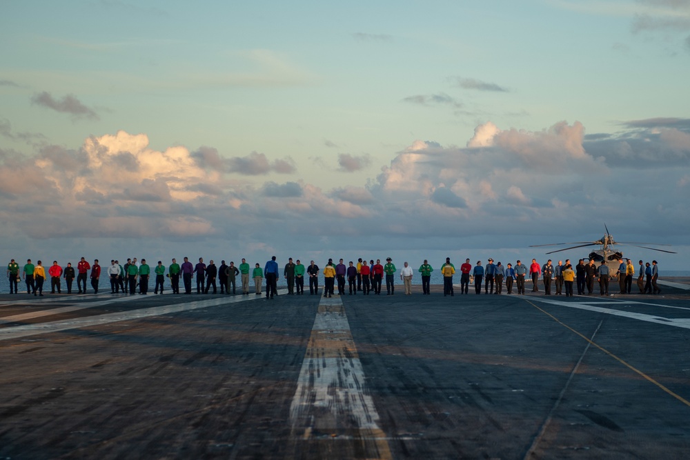 U.S. Sailors conduct a foreign object debris (FOD) walkdown on the flight deck of the aircraft carrier USS John C. Stennis (CVN 74)