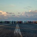 U.S. Sailors conduct a foreign object debris (FOD) walkdown on the flight deck of the aircraft carrier USS John C. Stennis (CVN 74)