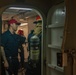 U.S. Navy Damage Controlman gives direction to the de-smoking team during a drill in the hangar bay of the aircraft carrier USS John C. Stennis