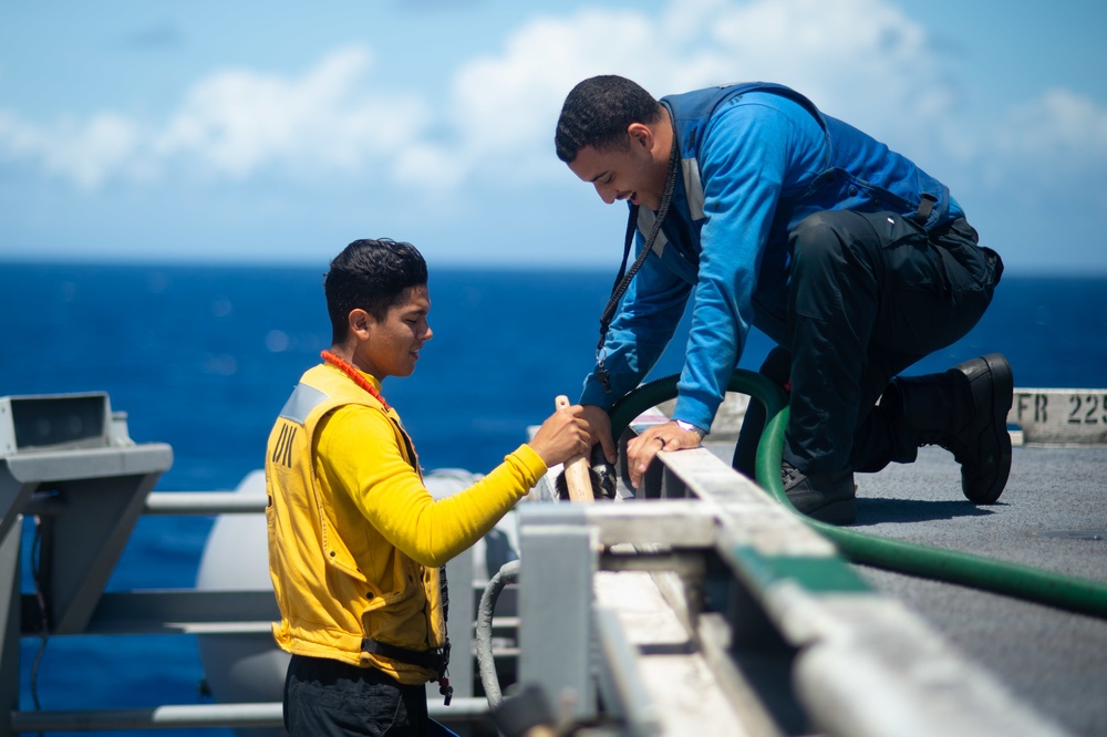 U.S. Navy Sailors clean debris