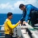 U.S. Navy Sailors clean debris