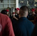 U.S. Navy Damage Controlman briefs his team after a drill in the hangar bay of the aircraft carrier USS John C. Stennis