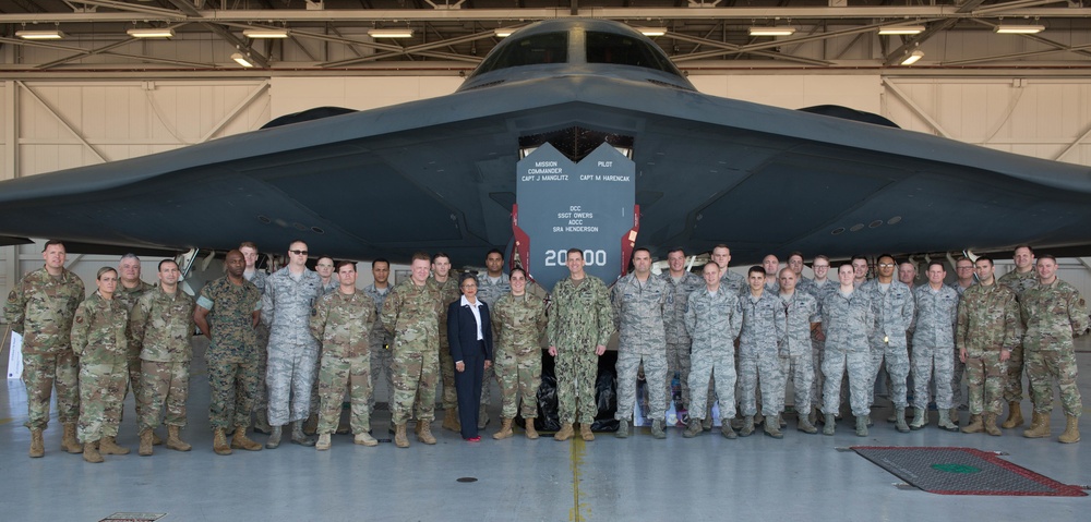 Vice Admiral Dave Kriete stands with members of Team Whiteman in front of a B-2 Spirit Bomber after a Dock Tour