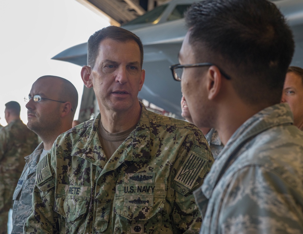 Vice Admiral Dave Kriete speaks with a Whiteman Airman during a B-2 Dock Tour