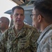 Vice Admiral Dave Kriete speaks with a Whiteman Airman during a B-2 Dock Tour