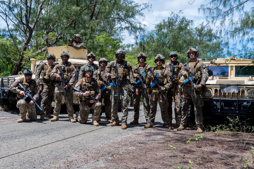 U.S. Marines and New Zealand Sailors pose for a photo during HYDRACRAB