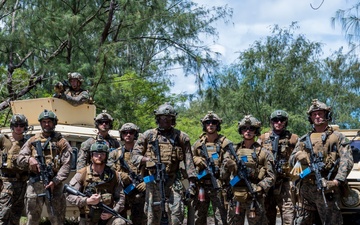 U.S. Marines and New Zealand Sailors pose for a photo during HYDRACRAB