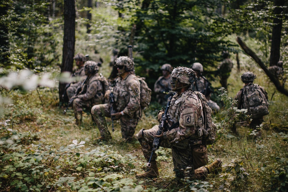 U.S. Army paratroopers set a screen and scan for enemy movement