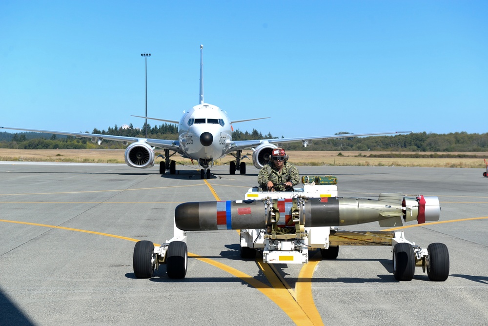 VP-4 Ordnance team Loads Torpedo