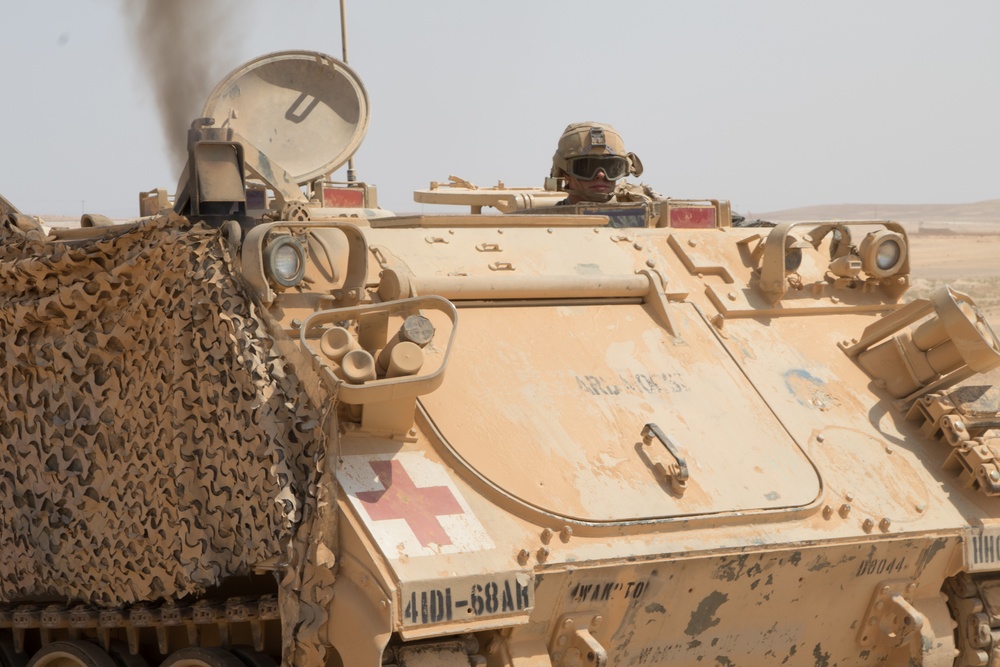 A medic maneuvers an M113 armored personnel carrier