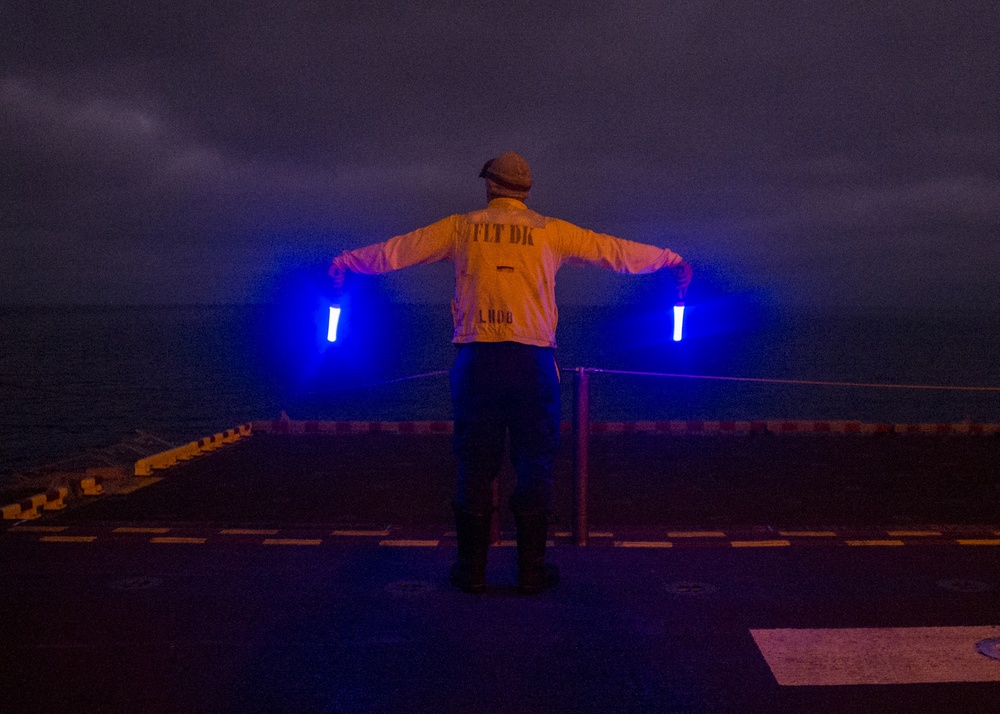 USS Makin Island Sailors Transfer Equipment at Night