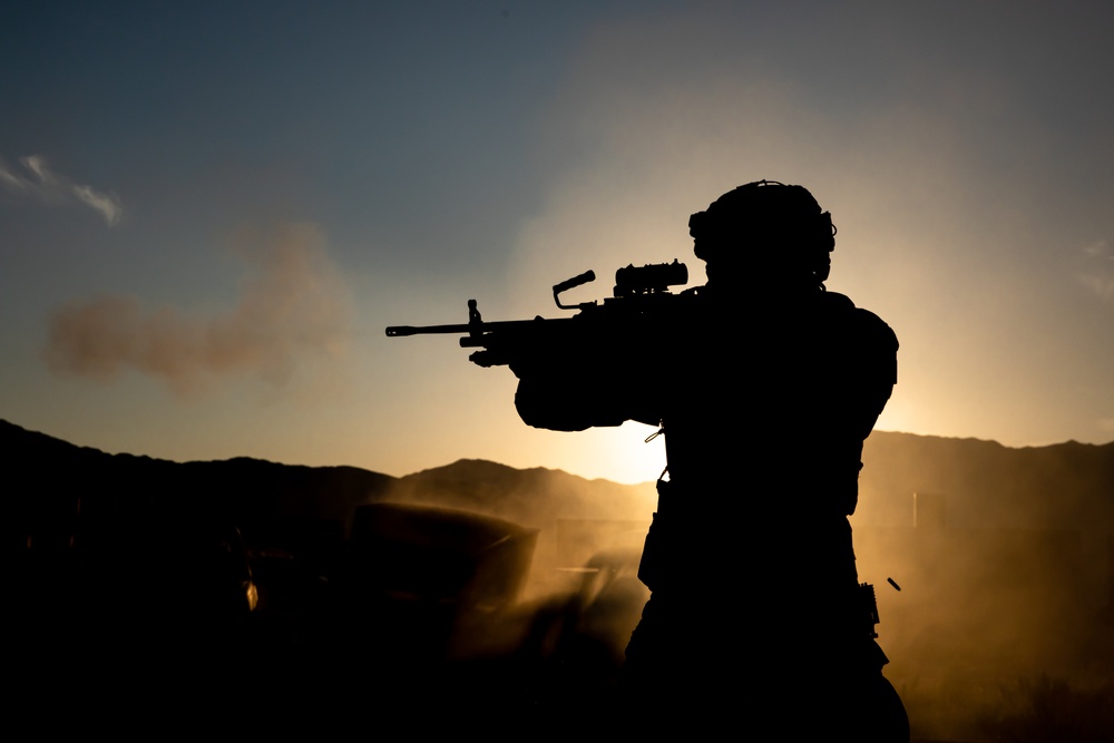 Soldier fires an M249 machine gun