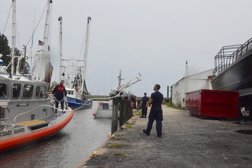 A Crewmember from Coast Guard Stations Charleston heaves a line to secure a 45-foot response boat