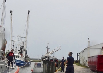 A Crewmember from Coast Guard Stations Charleston heaves a line to secure a 45-foot response boat