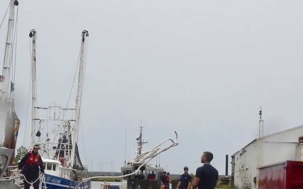 A Crewmember from Coast Guard Stations Charleston heaves a line to secure a 45-foot response boat