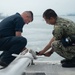 U.S. Navy Sailors lower the flag pole on the flight deck of the aircraft carrier USS John C. Stennis (CVN 74) as the ship departs Norfolk, Virginia