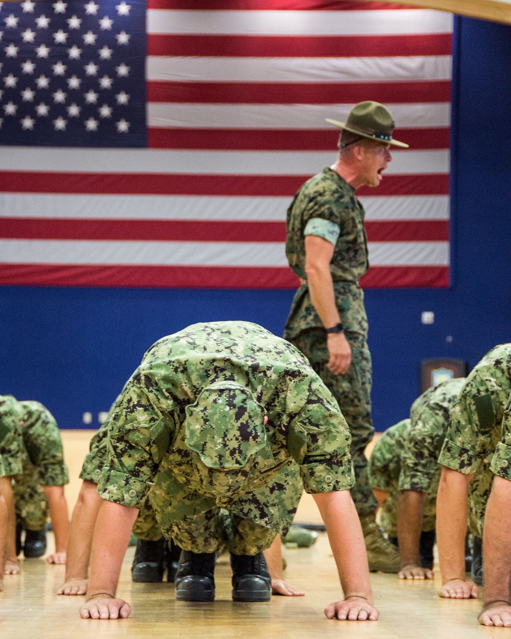 A Marine Corps Drill Instructor, assigned to Officer Training Command, Newport, Rhode Island, (OTCN) leads physical training for Officer Candidate School (OCS) class 02-20 prior to reaching their milestone as junior candidate officers on Sept. 6, 2019.