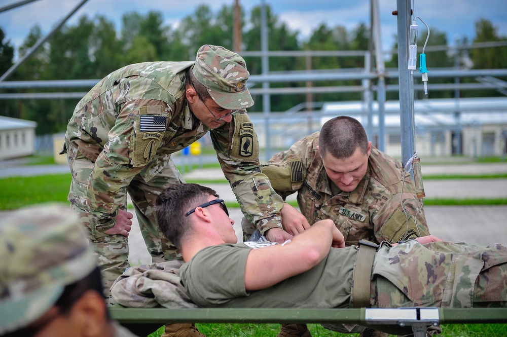 Paratroopers Work on Patient