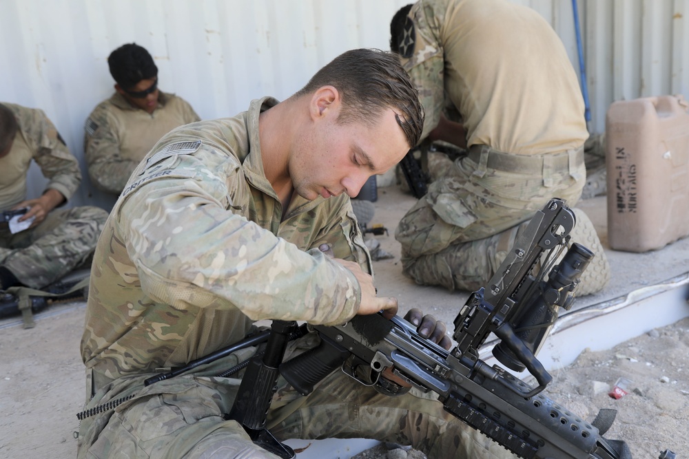 Lancer Brigade Soldier Cleans his rifle before live-fire at NTC