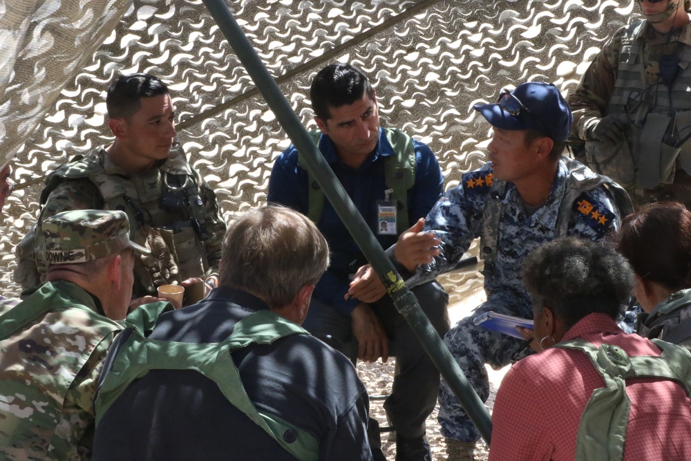 Col. Jonathan Chung speaks with training actors during a Key Leader Engagement at NTC