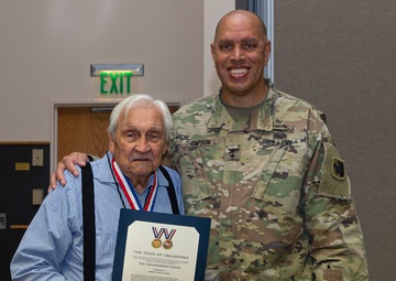 Maj. Gen. Thompson presents the Thunderbird Medal to Warrior Charles Coleman