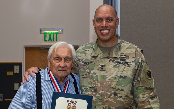 Maj. Gen. Thompson presents the Thunderbird Medal to Warrior Charles Coleman