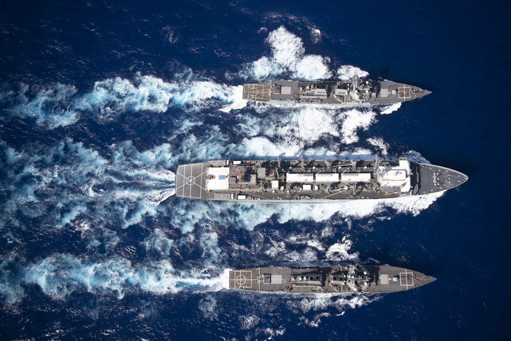 From top to bottom, the guided-missile destroyer, USS Gravely (DDG 107), fast combat support ship USNS Supply (T-AOE 6), and guided-missile destroyer USS Forrest Sherman (DDG 98), conduct a refueling-at sea