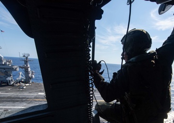 U.S. Sailor observes the aircraft carrier USS John C. Stennis (CVN 74)