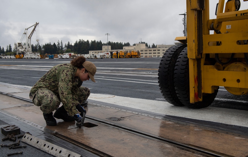 Sailor Removes Cover On Catapult