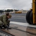 Sailor Removes Cover On Catapult