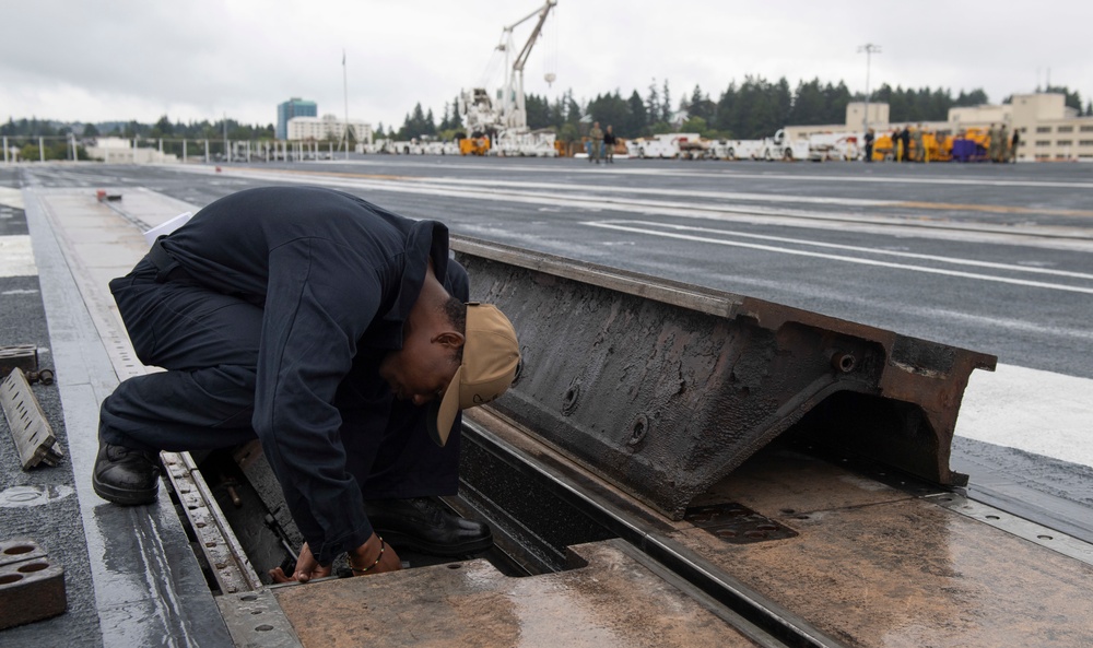 Sailor Conducts Maintenance On Catapult