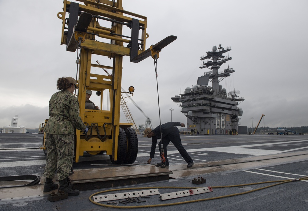 Nimitz Sailors Remove Cover On Catapult