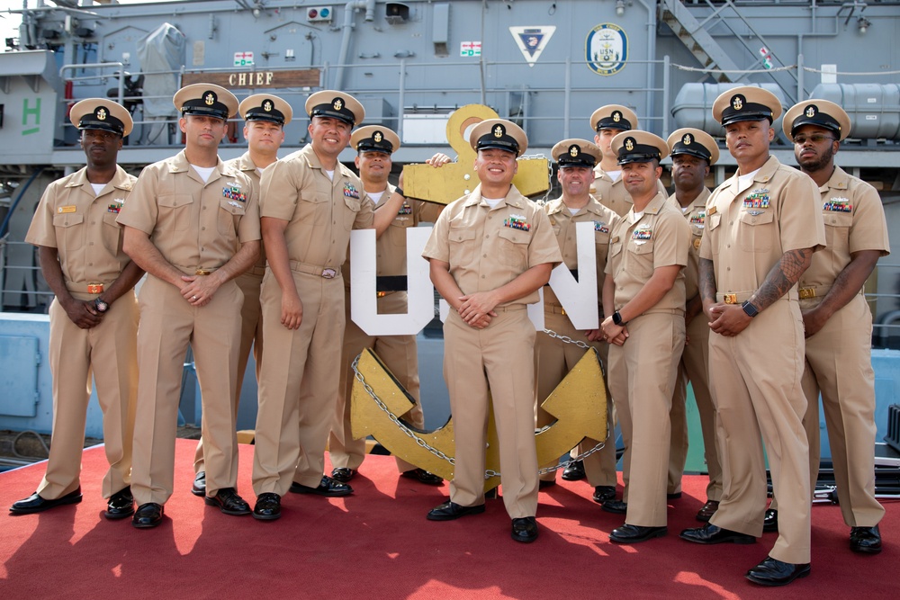 Chief Petty Officers aboard Avenger-class mine countermeasures ship USS Pioneer (MCM 9), pose for a celebratory picture during their Chief pinning ceremony.