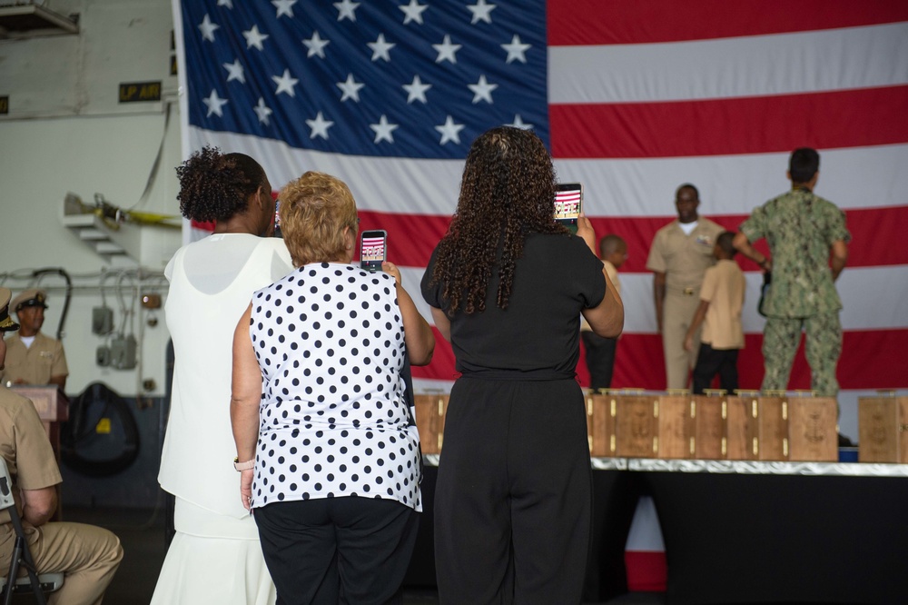 Family members take photos during a chief pinning ceremony