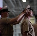 U.S. Navy Chief Aviation Boatswain's Mate (equipment) Brendan Fagan, receives his chief petty officer (CPO) combination cover from Senior Chief Mass Communication Specialist Holly Gray, during a CPO pinning ceremony