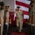 U.S. Navy chief salutes the side boys during a chief petty officer pinning ceremony