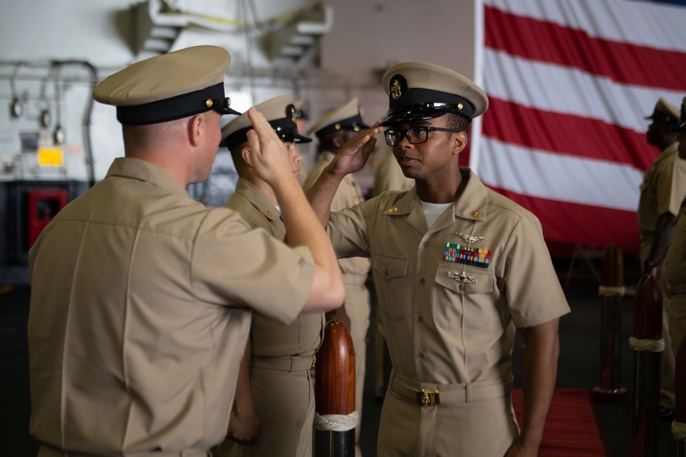 U.S. Navy Command Master Chief salutes Chief Personnel Specialist