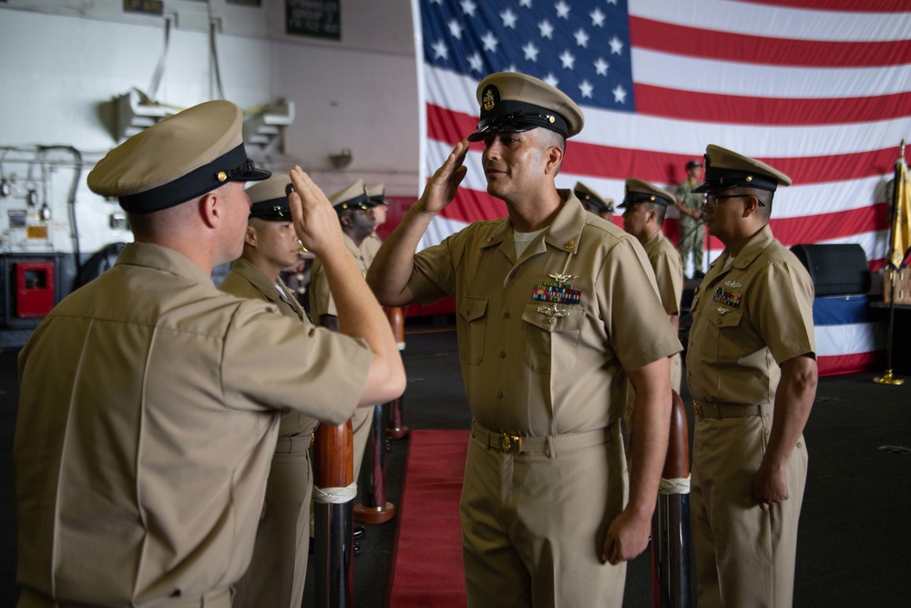 U.S. Navy Command Master Chief salutes Chief Aviation Boatswain’s Mate (Equipment)