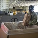 U.S. Navy Sailor packs a box