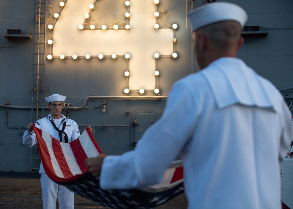 U.S. Sailors observe evening colors