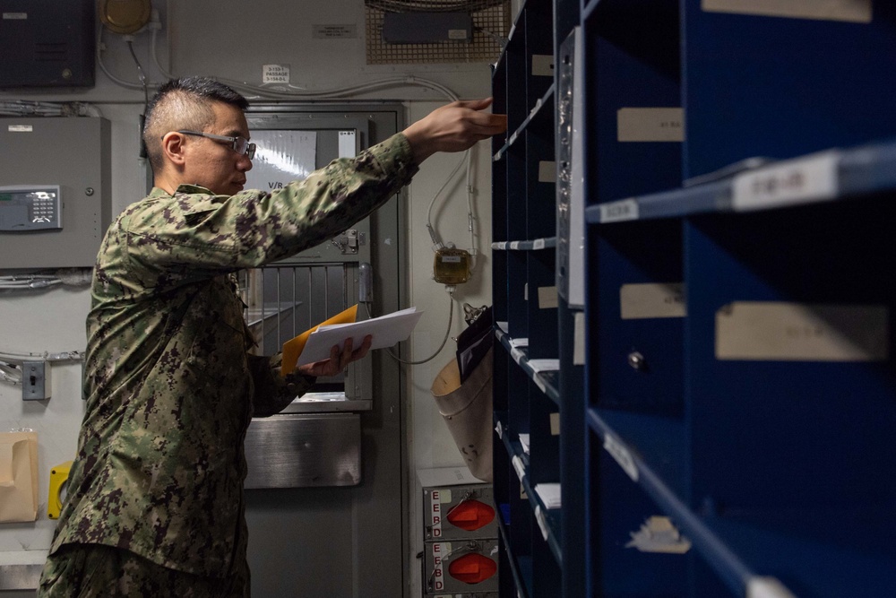 U.S. Sailor sorts mail
